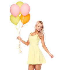 happy woman in dress with helium air balloons