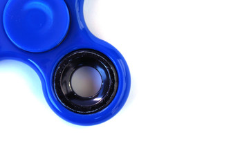 Detail of blue fidget spinner on white background