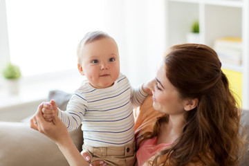 happy young mother with little baby at home
