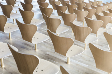 Designer wooden chairs in symmetry shot from the back
