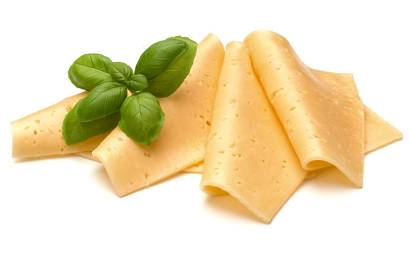 cheese slices and basil herb leaves isolated on white background cutout