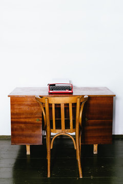 Vintage red typewriter on wooden desk