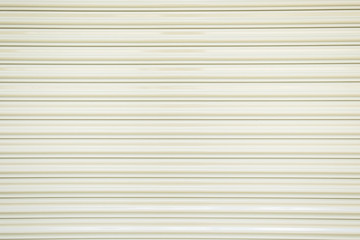 Obraz premium The texture of corrugated metal sheet, white or gray galvanizes steel rolling shutter.