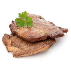 Cooked fried pork meat with parsley herb leaves garnish isolated on white background cutout