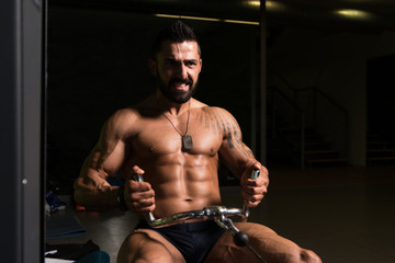 Fototapeta na wymiar Fitness Man Exercising Back In The Gym