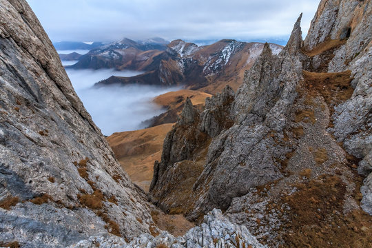 Beautiful scenic autumn landscape of Bolshoy Tkhach rocky mountain ridge under cloudy sky at dusk in North Caucasus Mountains, Russia © Wilding