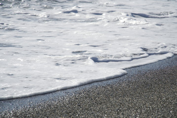 Wave white foam on the beach                          