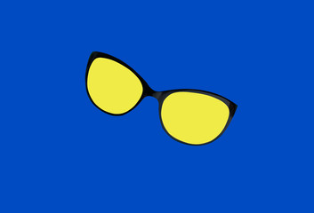 Yellow sunglasses isolated on blue background, color contrast