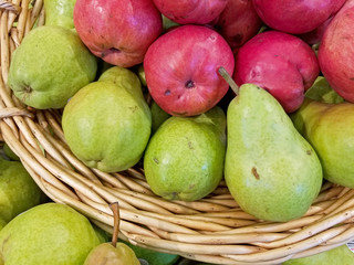 red and green pears in wicker basket