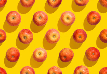 Seamless colourful apple pattern on yellow background