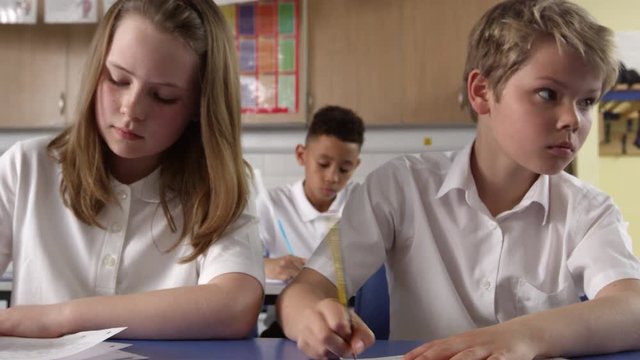 Close Up Of Pupils Working At Desks In Classroom Shot On R3D