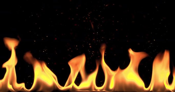 Slow motion flames with hot flying embers. Real flames filmed with slow motion camera. Fantastic background. Filmed on black
