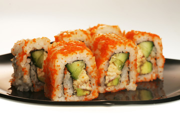 japanese  rolls on black plate.