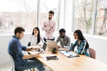 Young professionals working on laptops in an office