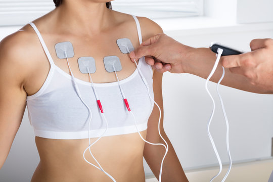 Therapist Giving Electrodes Therapy To Woman