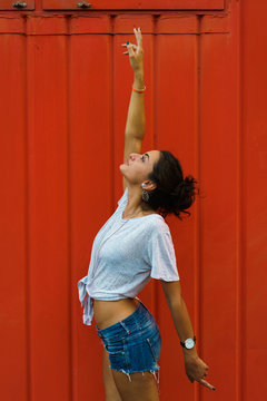 Expressive playful girl posing on red