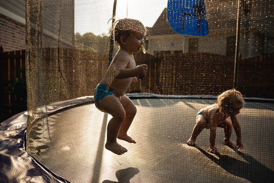Toddlers playing on trampoline