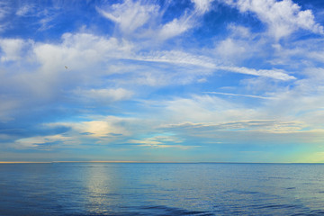 Fototapeta na wymiar amazing view of azure sky over rippled surface of cold sea at sunrise 
