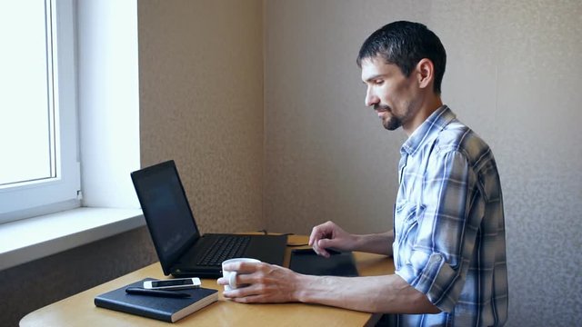 Man working behind laptop at home