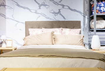 Bed maid-up with clean white pillows and bed sheets in beauty room, Close-up.