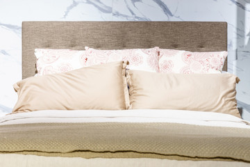 Bed maid-up with clean white pillows and bed sheets in beauty room, Close-up.
