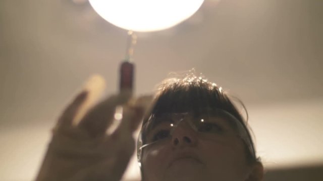 woman doctor with a syringe with blood squeezes blood from a syringe