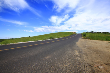 asphalt road on grassland