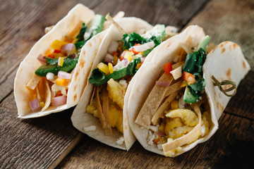 Breakfast tacos with eggs, avocado and fresh cut vegetables
