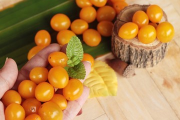 Fresh yellow tomatoes organic on wood background