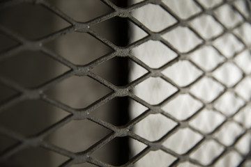 Mesh security covering in parking garage .