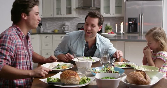 Male gay couple and daughter dining in their kitchen, shot on R3D