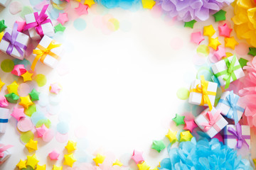 Paper balls, confetti and gifts in pastel colors. White background.