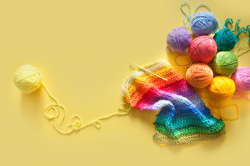 Balls of yarn lie in a waffle cone for ice cream. Coloured wool.