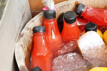 Strawberry juice in bottle with ice bucket
