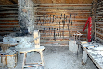 Vintage blacksmith shop interior view indoors.