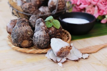 Boiled taro with sugar on wood background