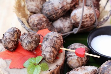 Boiled taro with sugar on wood background