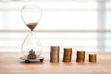 Deadline and time is money concept with hourglass