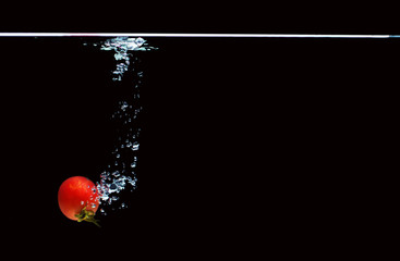 Tomato falls into the water.
