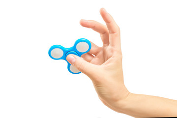 Closeup female hand holding fidget spinner as a popular toy for relaxing.