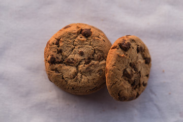 Stack of chocolate chips cookies on brown background