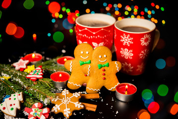 Christmas card - gingerbread man gingerbread, christmas decor, snow, candles, cup with cocoa, tea or coffee and Christmas light