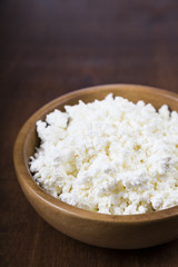 Cottage cheese in a wooden bowl