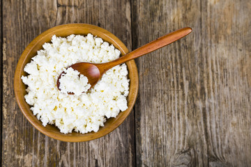 Cottage cheese in a wooden bowl