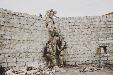 rangers team climbing from a wall