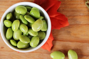 Green japanese soybean delicious on wood background