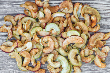Dried apples on wooden background. Healthy vegetarian snack. Closeup