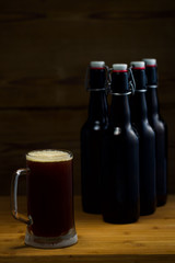 Beer glasses and beer bottles on a wooden background