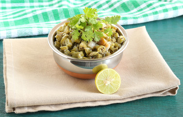 Green beans curry, an healthy, traditional and popular Indian vegetarian food, and a lemon slice.