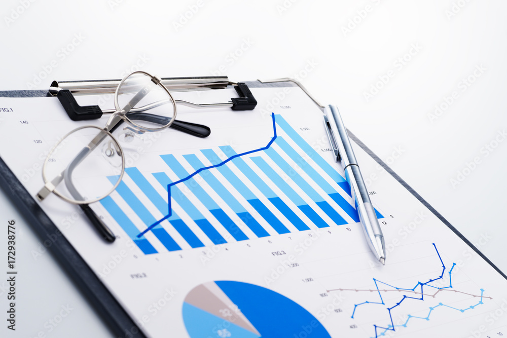 Poster Growth chart. Reviewing business report. Concept image of analyzing data. Documents and glasses on white reflection background.
